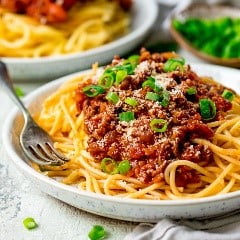 A bowl of pasta with many different types of food on a plate
Description automatically generated